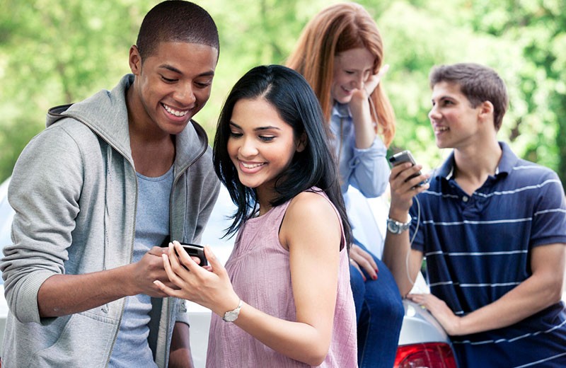 Group of Teenagers Looking at Their Cell Phones