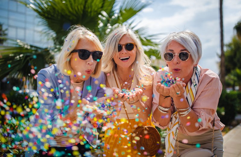 Three Women Blowing Confetti