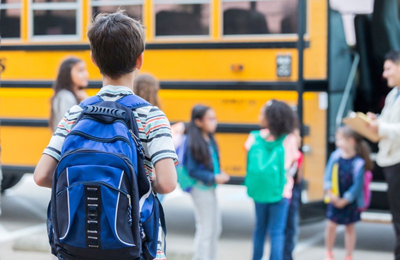 Child Getting on the School Bus