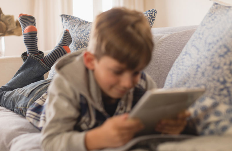 Child Reading an Article in a Magazine