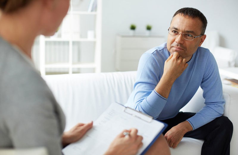 Therapist Taking Notes While Talking to a Patient